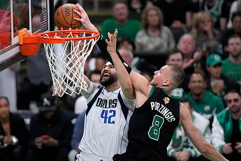 Kristaps Porzingis blocks a shot by Maxi Kleber